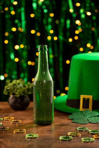 Free photo arrangement with beer bottle and green hat