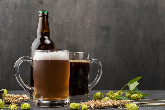 Free photo arrangement with beer mugs and bottle