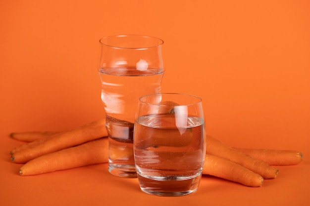 Arrangement with carrots and glasses of water