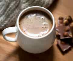 Free photo arrangement with cup of coffee and chocolate close-up