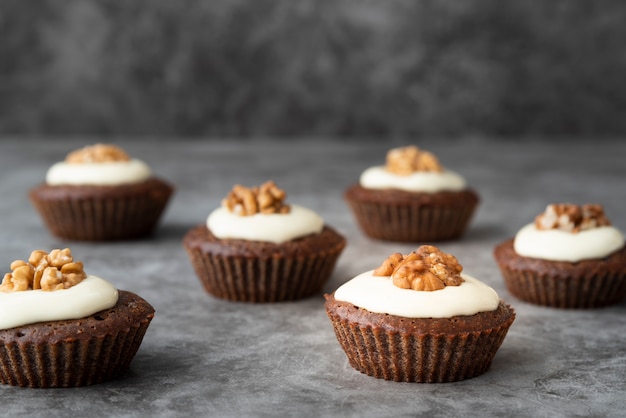 Arrangement with delicious cupcakes and stucco background