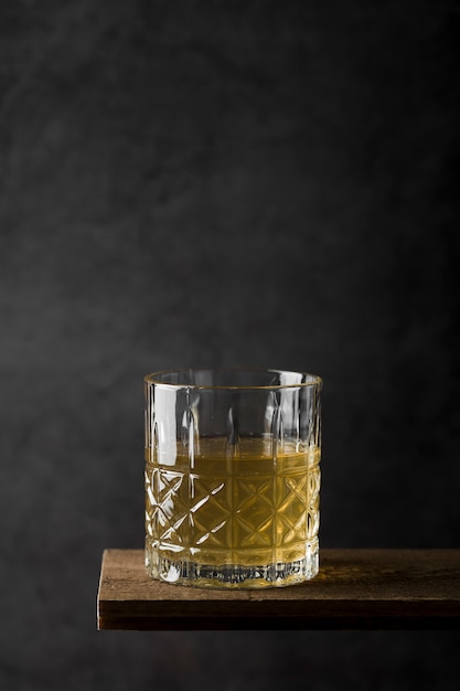 Arrangement with drink glass on wooden table