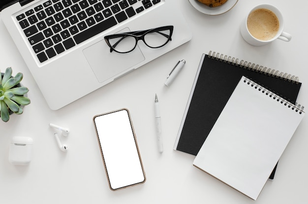 Arrangement with empty notepad on desk