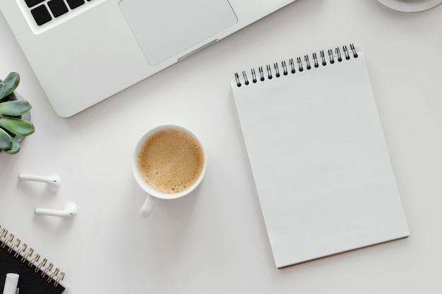 Arrangement with empty notepad on desk