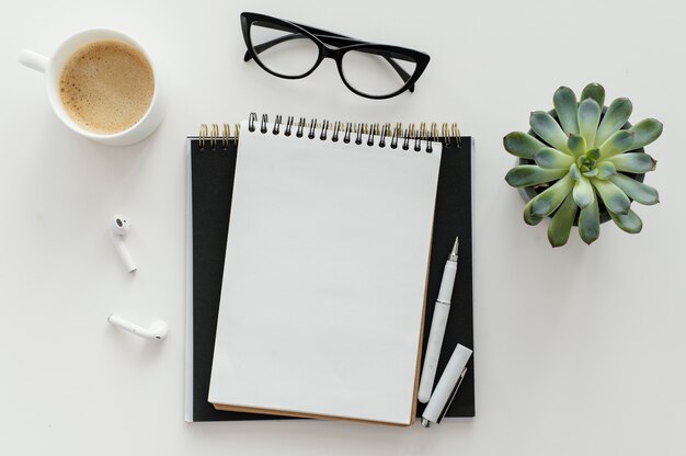 Arrangement with empty notepad on desk