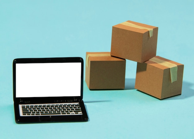 Free photo arrangement with laptop and boxes