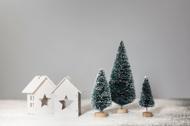 Free photo arrangement with little christmas trees and houses