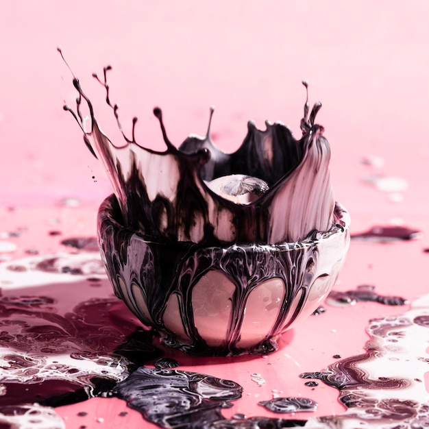 Free photo arrangement with paint splash and cup