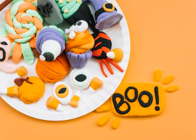 Free photo arrangement with plasticine halloween attributes