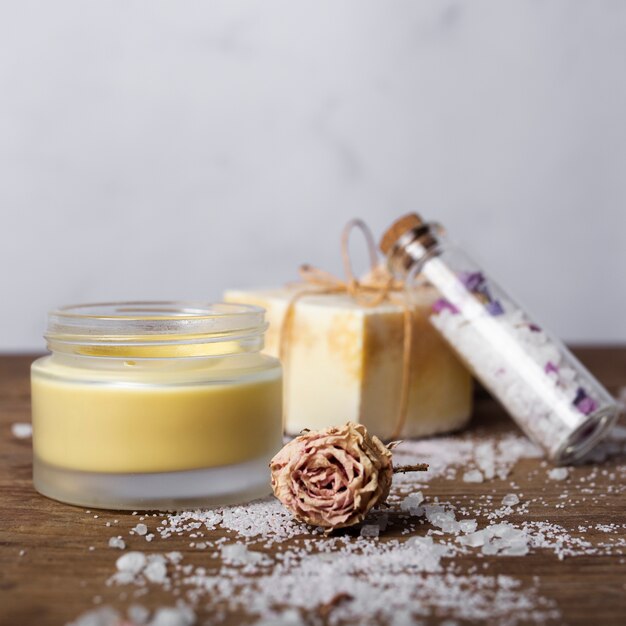 Arrangement with salt and soap on wooden table