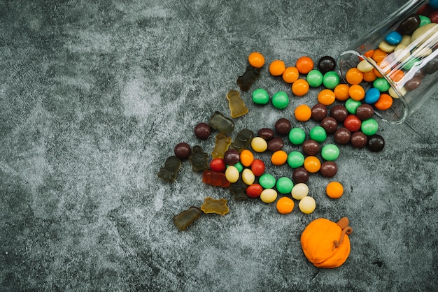 Arrangement with scattered sweets and candy pumpkin