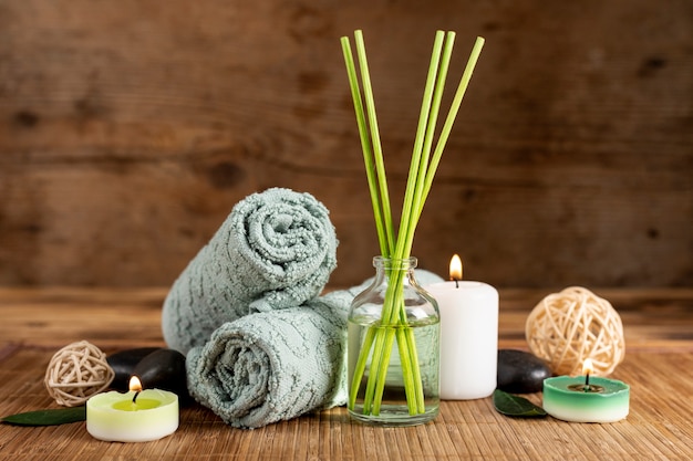 Free photo arrangement with spa scented sticks and towels