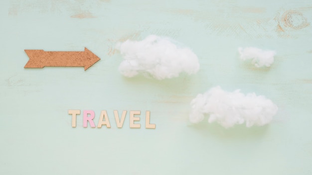 Free photo arrow and text travel with clouds