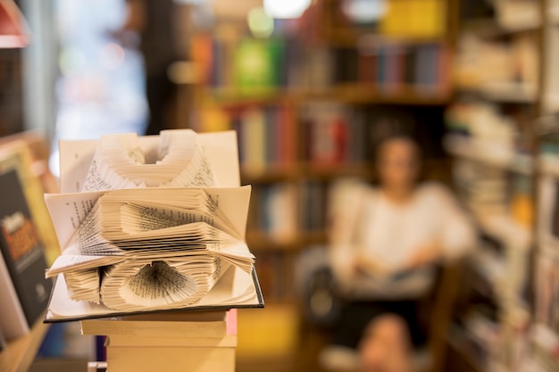 Free Photo art of book pages against person reading in library