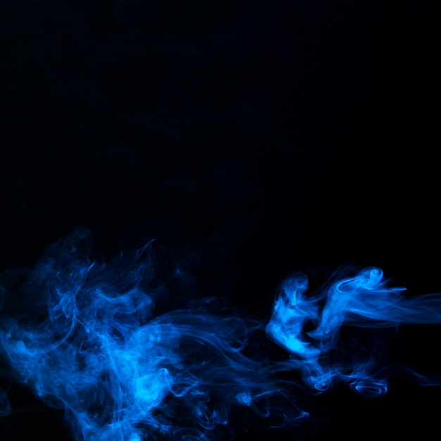 Free photo art of bright blue smoke on black background with copy space