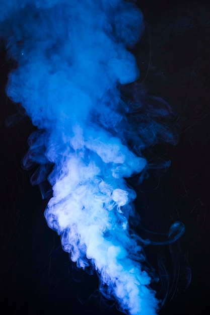 Free photo art of bright blue smoke fumes on black background