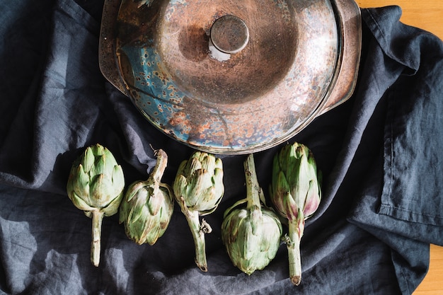 Artichokes near saucepan