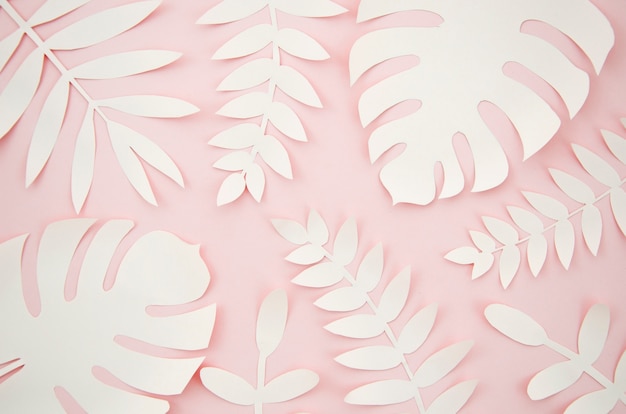 Free Photo artificial leaves paper cut style with pink background