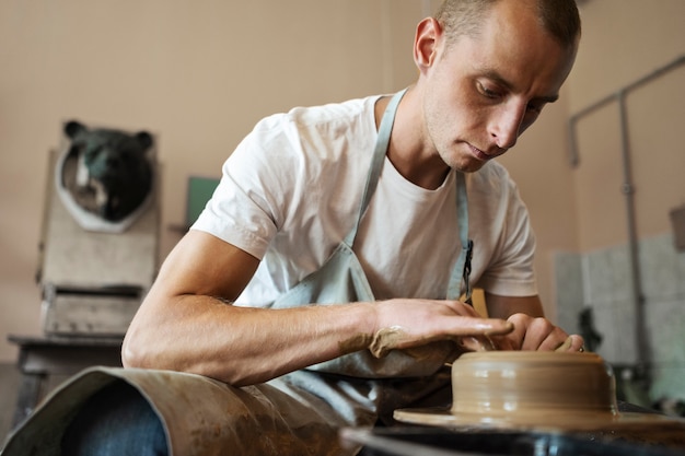 Artisan doing pottery in studio low angle