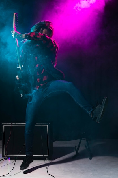 Artist playing guitar and dancing