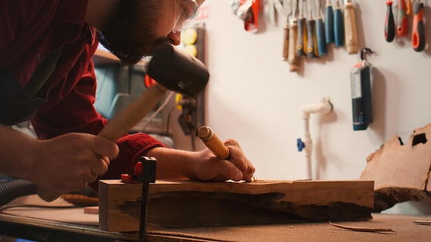 Free Photo artist uses vice tool to clamp piece of wood shaping log