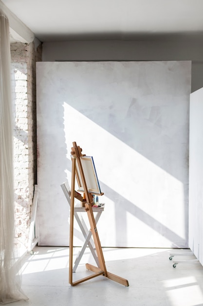 Free Photo artistic easel and canvas in studio