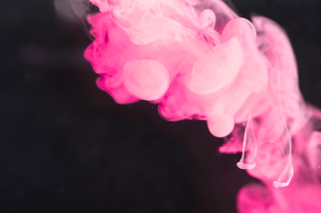 Free photo artistic powerful pink smoke on black screen