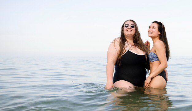 Artistic shot with friends standing in the water