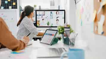 Free photo asia businesspeople using desktop talk to colleagues discussing business brainstorm about plan in video call meeting in new normal office.