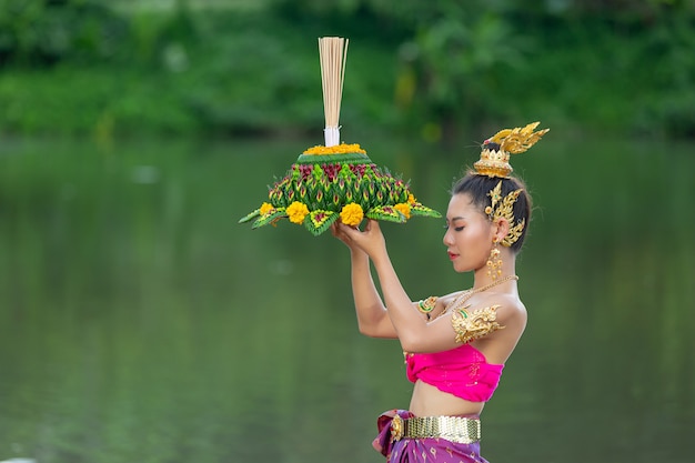 Free photo asia woman in thai dress traditional hold kratong. loy krathong festival