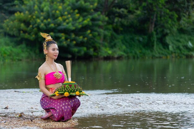 Asia woman in Thai dress traditional hold kratong. Loy krathong festival