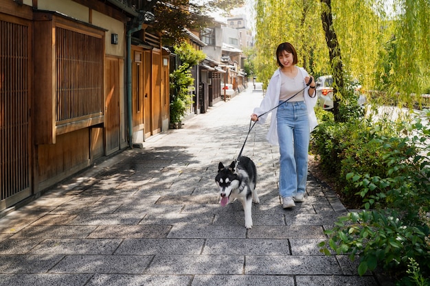 Free Photo asia woman walking her husky dog outdoors