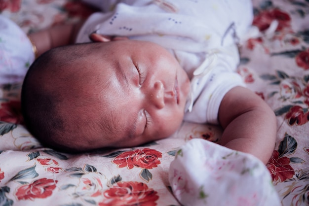 Asian baby sleeping in bed