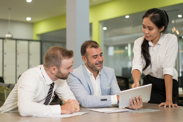 Asian business lady working with coworkers at desk