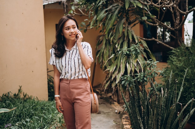 Asian business woman on a vacation talking on phone