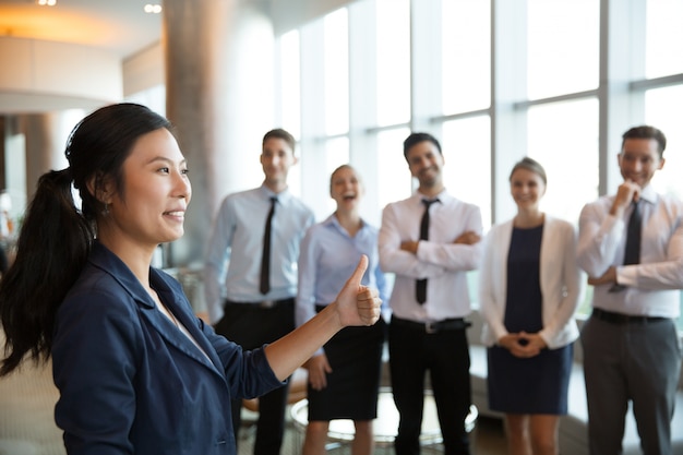 Free photo asian businesswoman with thumb up gesture