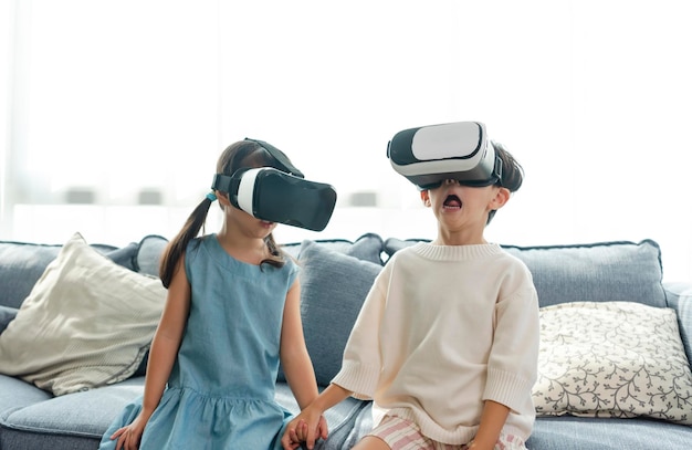 Asian child feeling excited while using 360 VR headset for virtual reality Metaverse at home