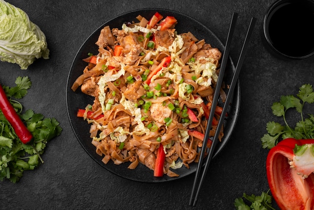 Free Photo asian dish on plate with chopsticks and vegetables