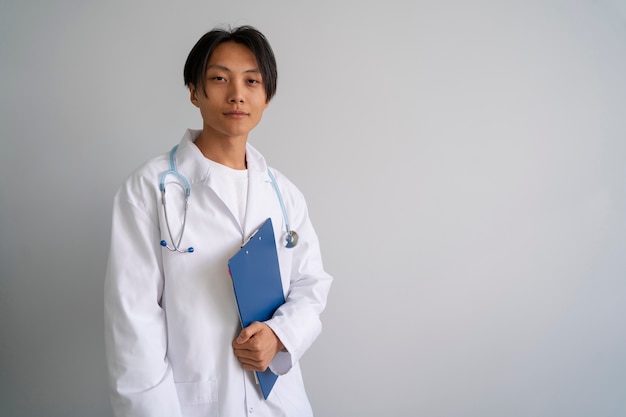 Asian doctor with lab coat front view