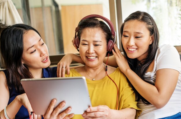 Asian family is using digital tablet together