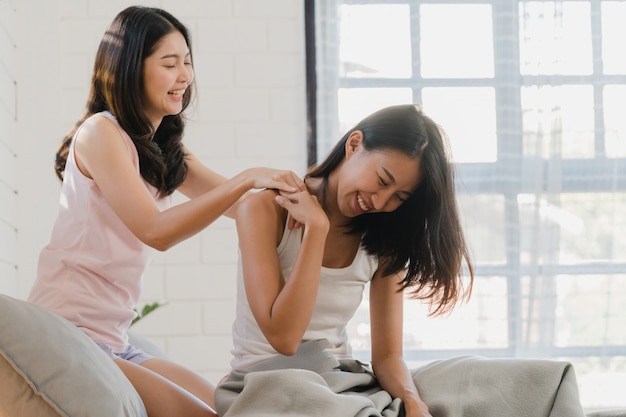 Asian Lesbian lgbtq women couple massage each other at home. 