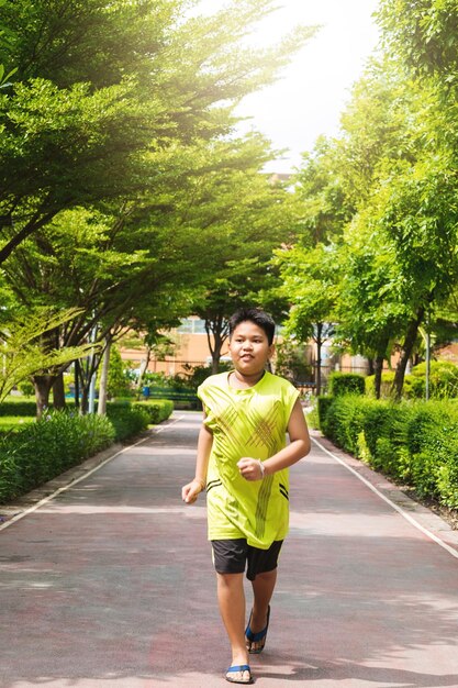 Asian man jogging at the park in sunny morning