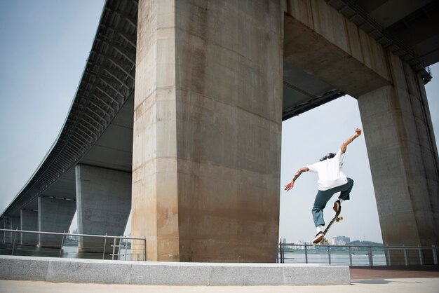 Asian man skateboarding in the city outdoors