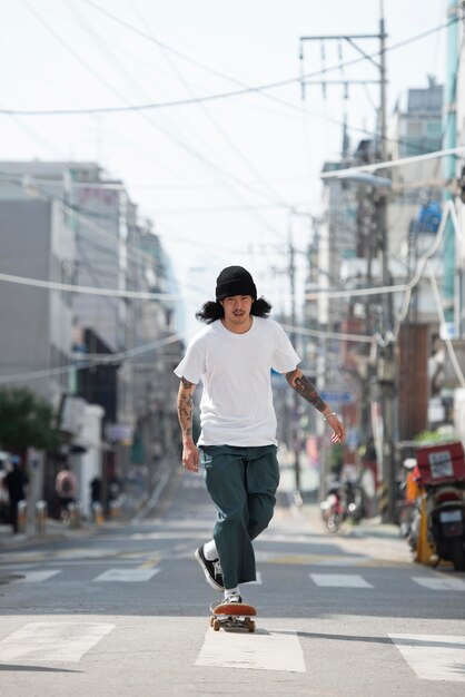 Asian man skateboarding outdoors