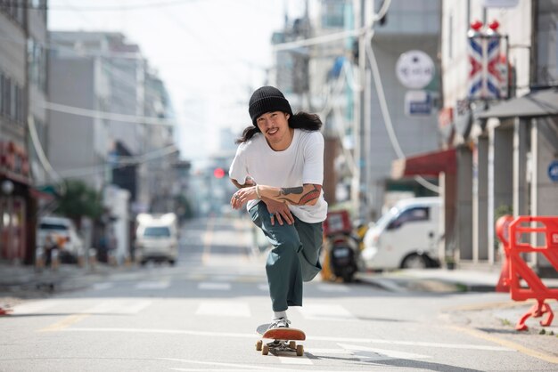 Asian man skateboarding outdoors