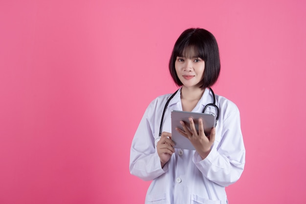 asian medical doctor woman with white lab coat on pink