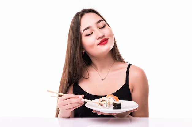 Free photo asian model hold chopsticks with sushi rolls isolated