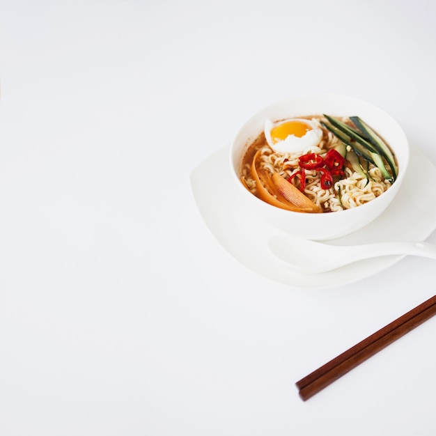 Free photo asian soup and chopsticks on white