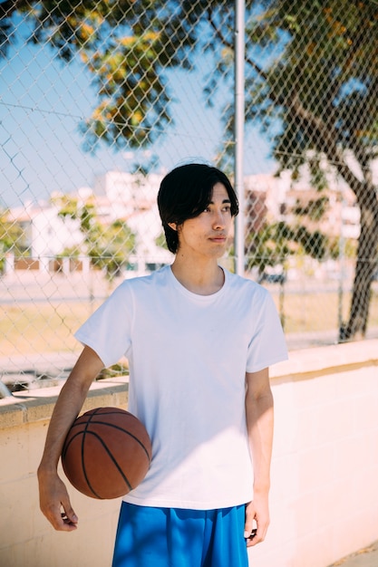 Free photo asian teen student ready for basketball game