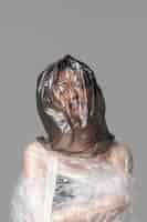 Free photo asian woman being covered in plastic bags